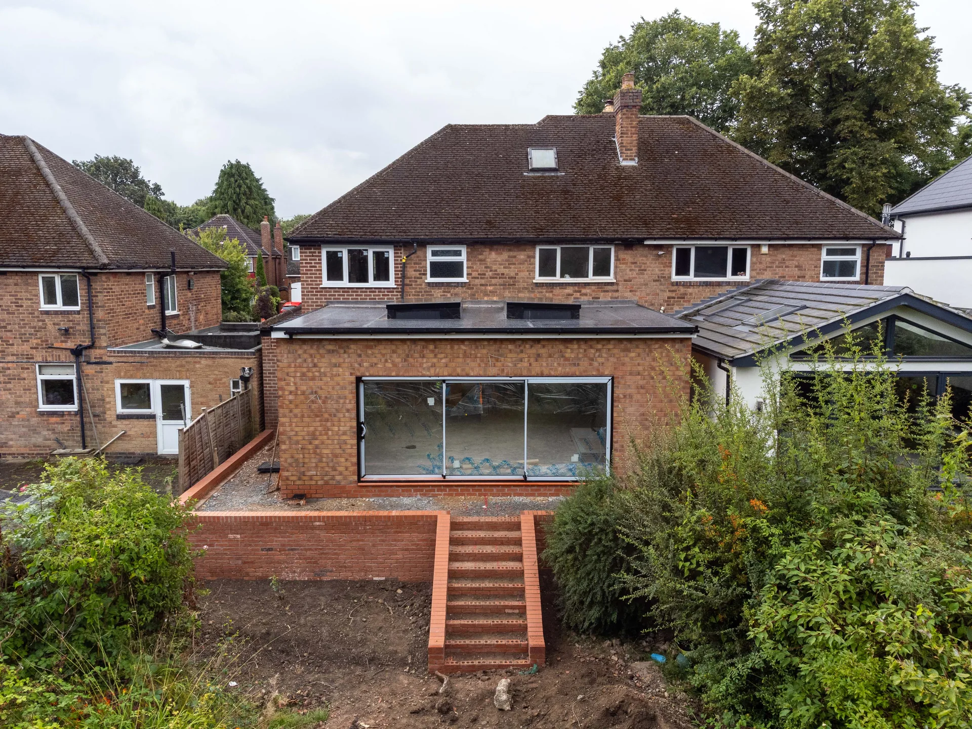 External air conditioning condenser units mounted to the brickwork of a house