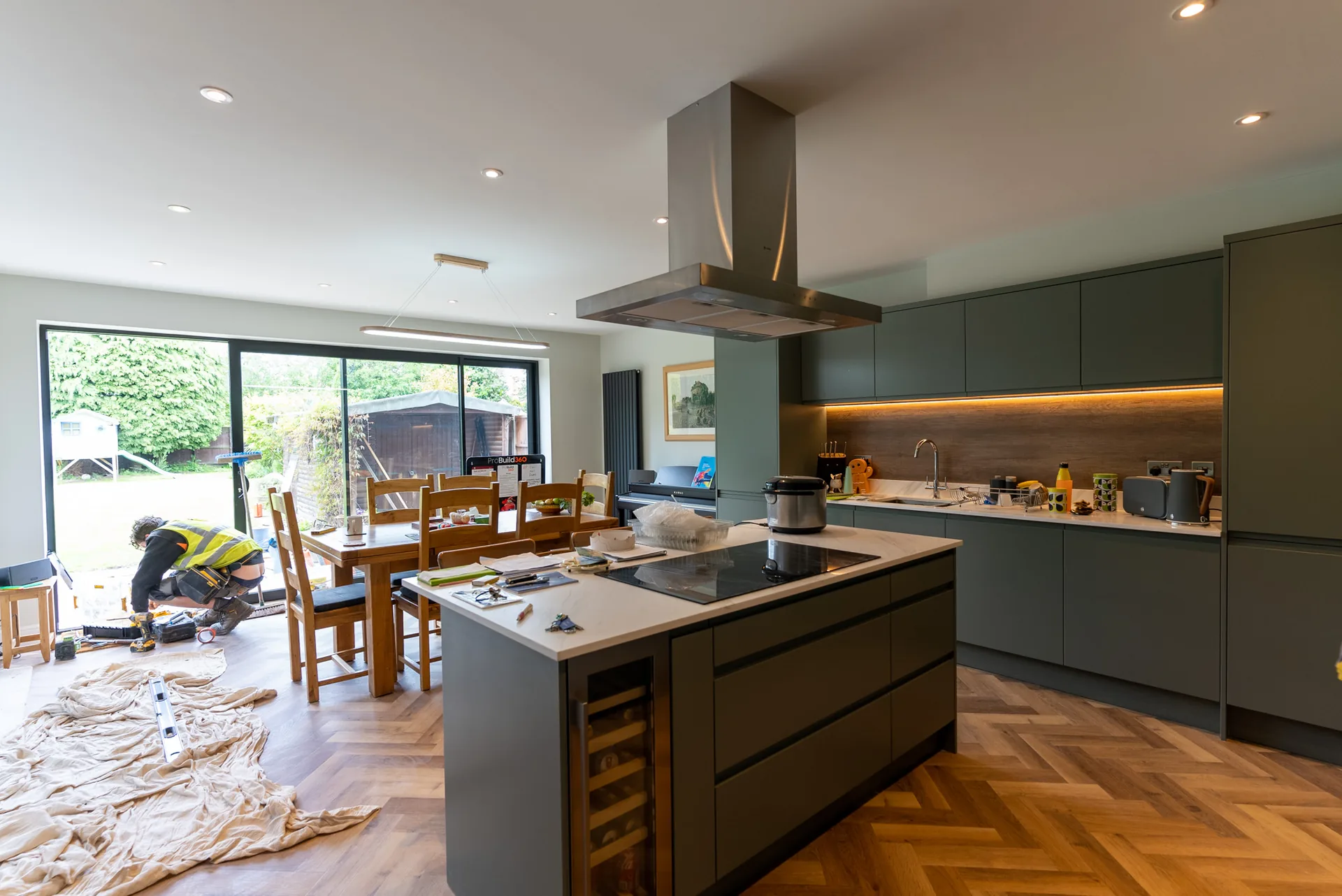 A finished interior lit by recessed and linear lighting after completion