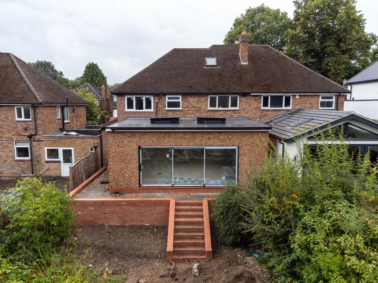 External air conditioning condenser units mounted to the brickwork of a house