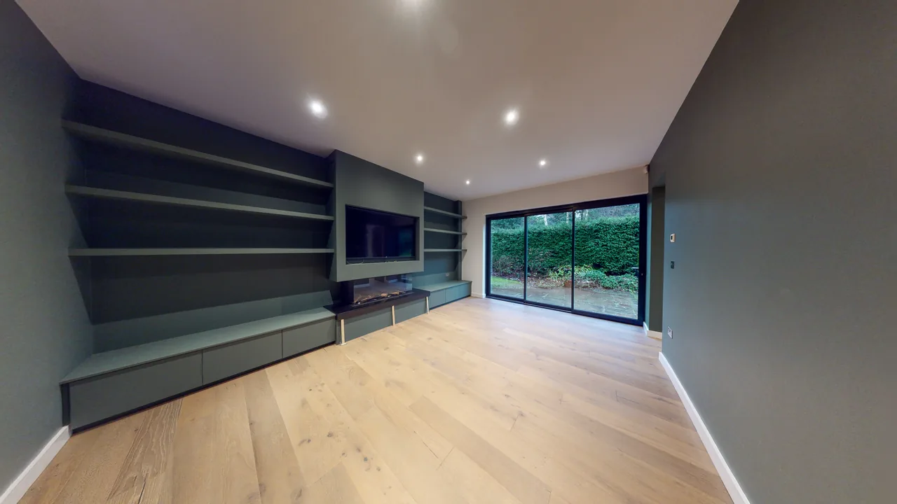 A media wall with an integrated display and concealed cabling in a finished living room