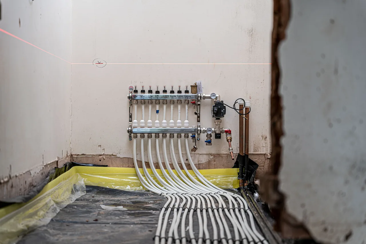 Underfloor heating pipework laid out and connected back to a manifold before screeding