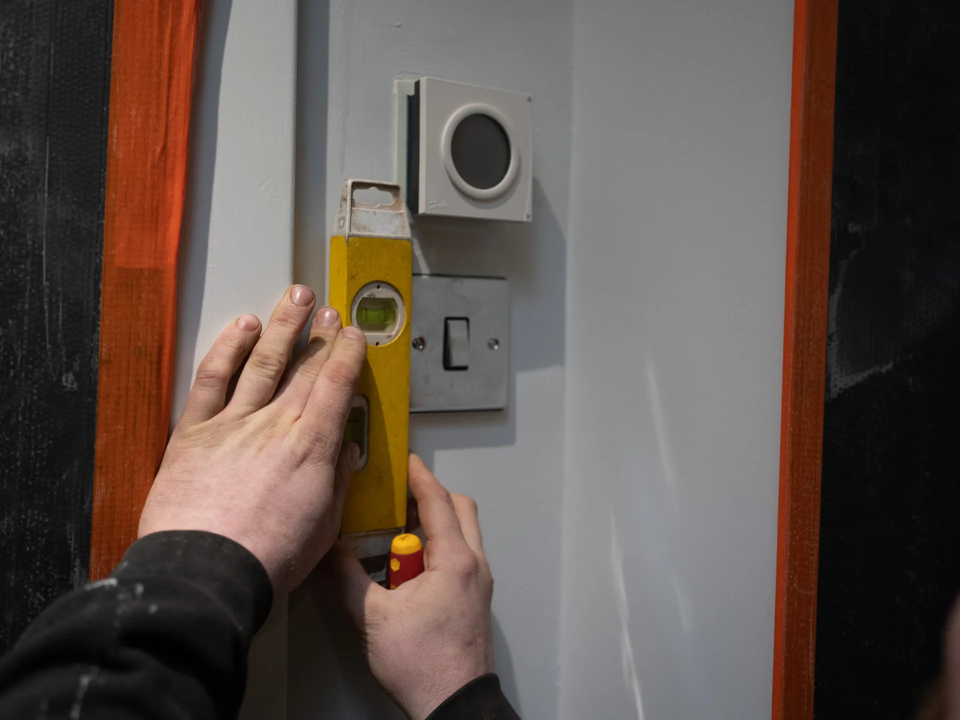 A wall-mounted control panel installed in a finished interior