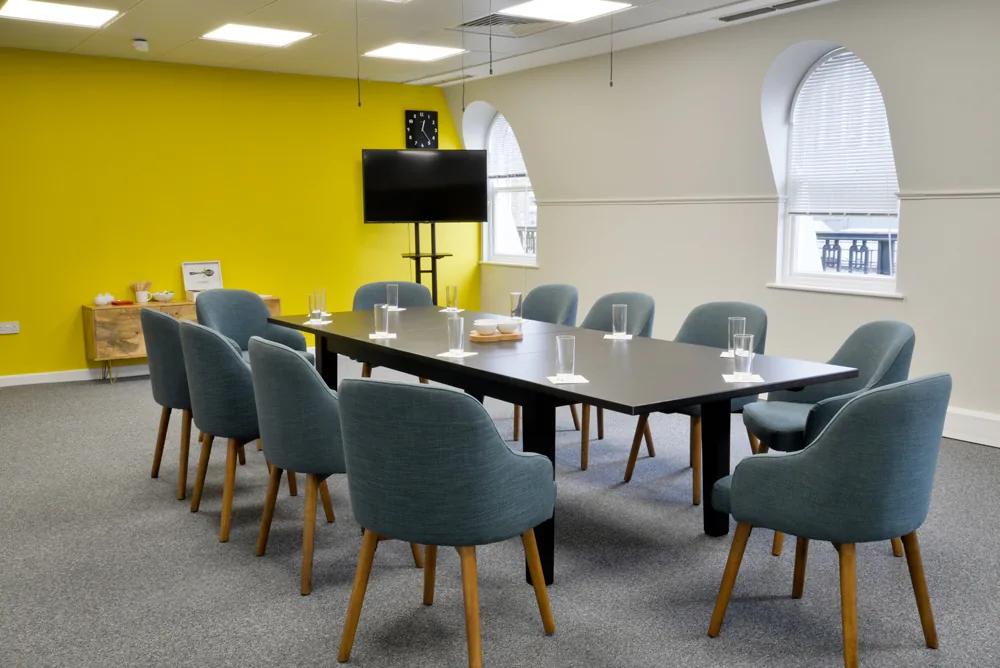 A fitted-out boardroom with concealed lighting and AV